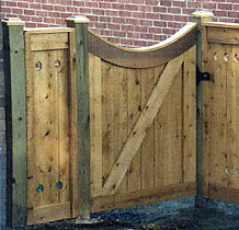 square lattice wood fence with arched square lattice gate by Elyria Fence